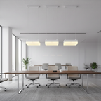 Modern conference room with wooden table and chairs in a bright office setting